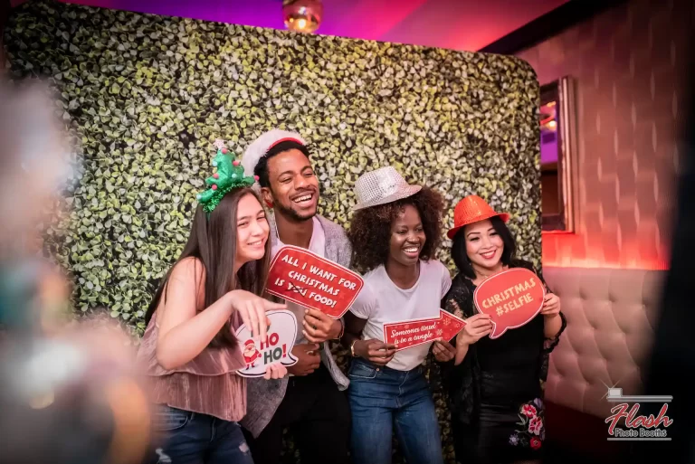 Group photo filled with holiday spirit in a stylish Flash Photo Booths holiday-themed setup.